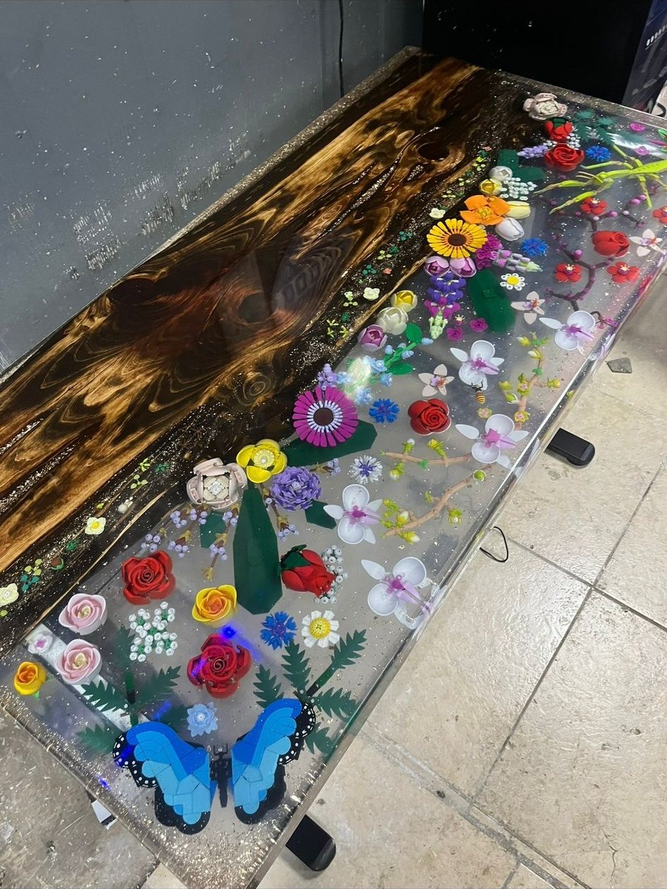 Vivid wildflower resin river table with a blue butterfly