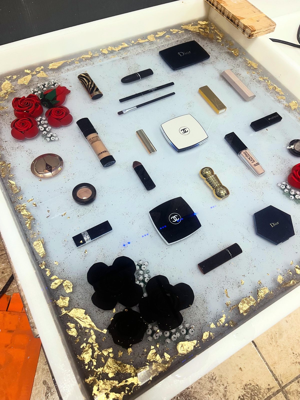 Luxury cosmetics vanity tray with roses and gold leaf